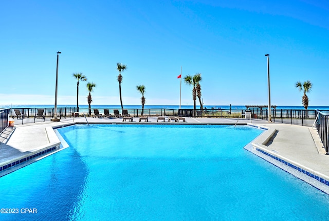 view of pool featuring a water view