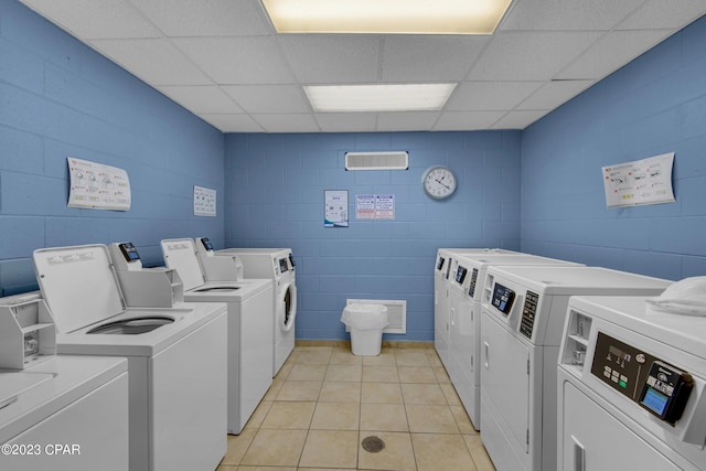 washroom with independent washer and dryer and light tile patterned floors