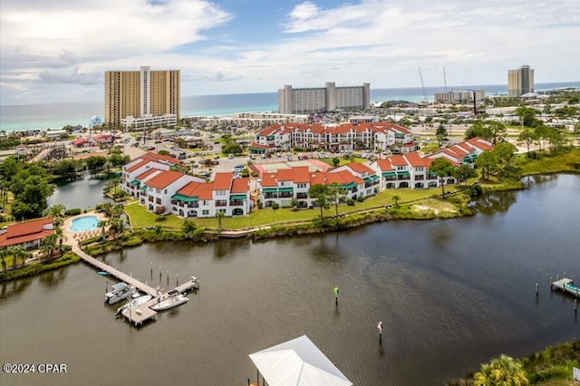 birds eye view of property featuring a water view and a city view