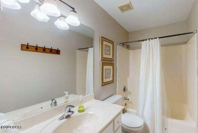 full bathroom with vanity, shower / bath combo with shower curtain, and toilet