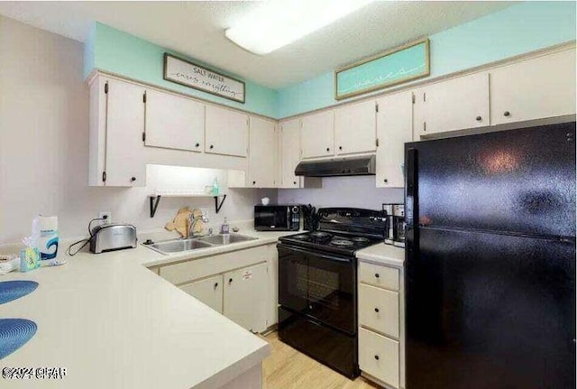 kitchen with white cabinets, light wood-type flooring, sink, and black appliances