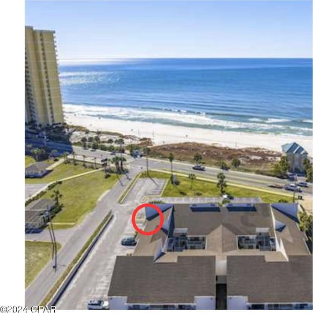 birds eye view of property with a view of the beach and a water view