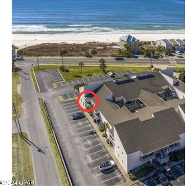 birds eye view of property featuring a water view and a view of the beach