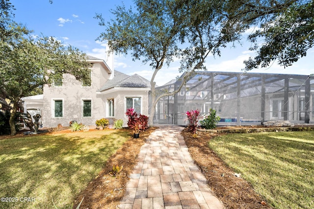 view of front of home featuring a front yard and a lanai