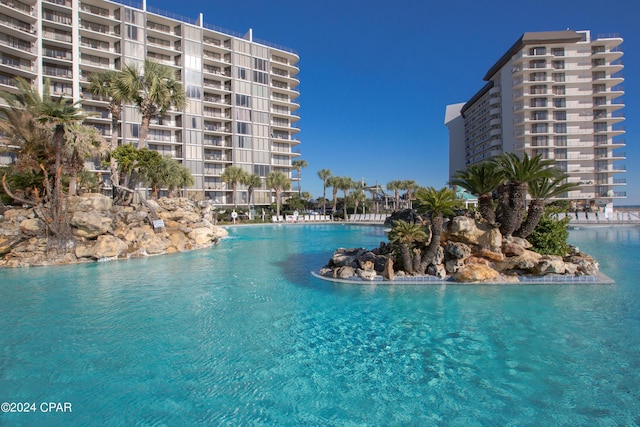 view of pool with a water view