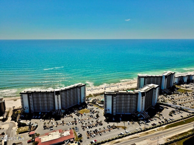 aerial view with a water view and a beach view