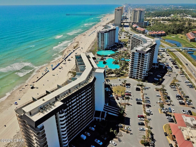 birds eye view of property with a water view and a beach view