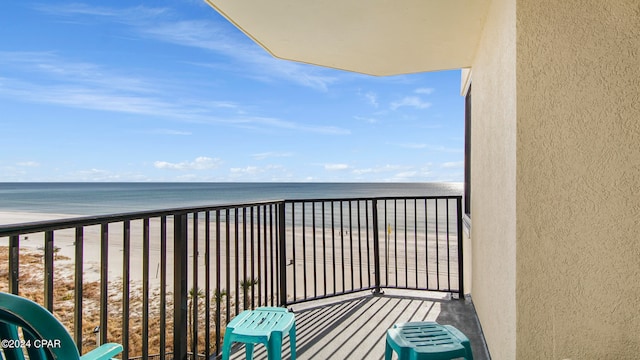 balcony featuring a water view and a view of the beach