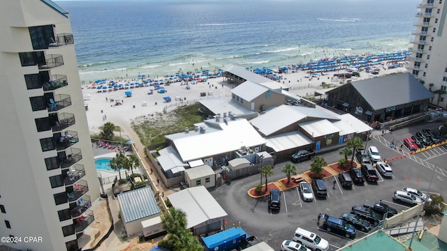 birds eye view of property with a view of the beach and a water view