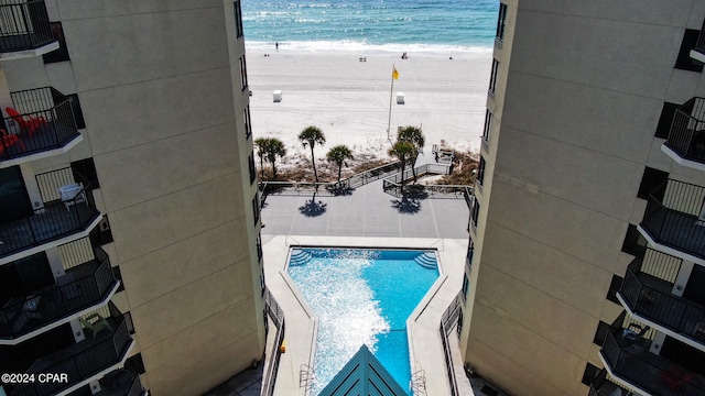 view of pool with a beach view and a water view