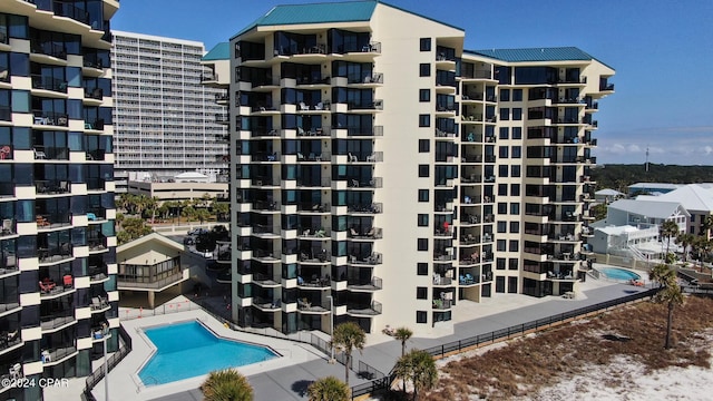 view of building exterior featuring a community pool