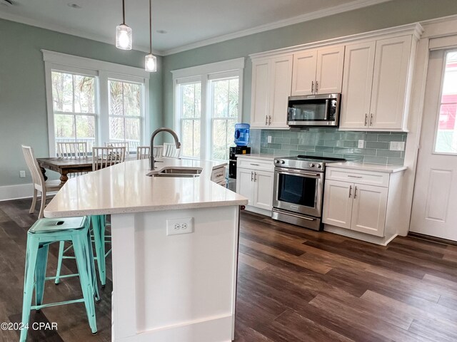 living room with dark hardwood / wood-style floors, crown molding, and plenty of natural light