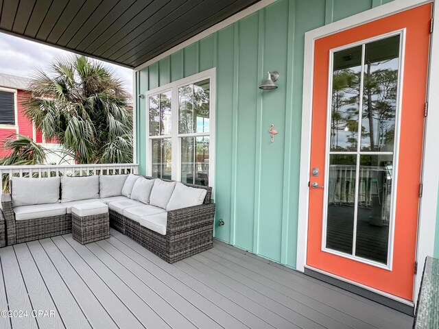 wooden terrace with an outdoor hangout area