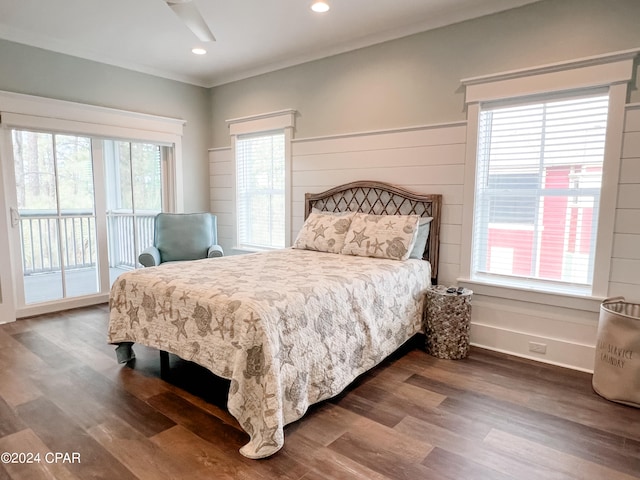 bedroom featuring dark hardwood / wood-style floors, access to outside, and multiple windows