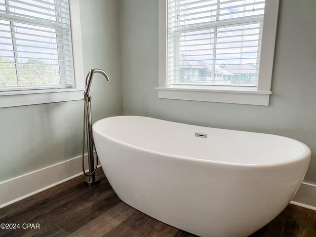 bathroom featuring independent shower and bath and hardwood / wood-style flooring