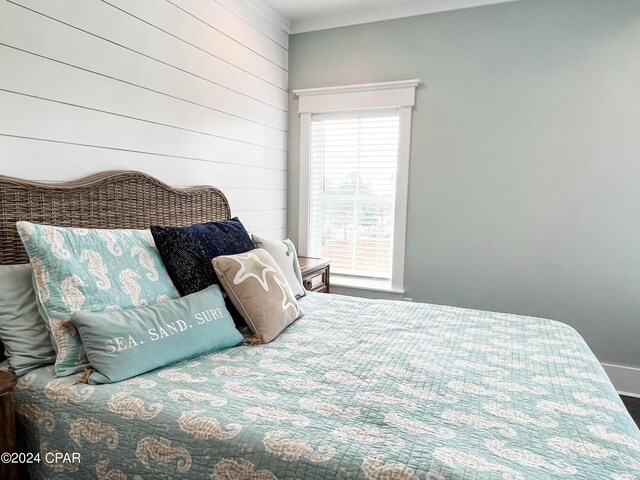 bedroom featuring multiple windows, crown molding, ceiling fan, and dark wood-type flooring