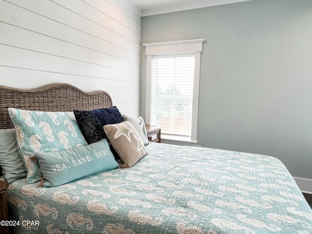 bedroom featuring ornamental molding and multiple windows