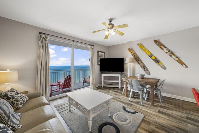 living room featuring ceiling fan and wood-type flooring