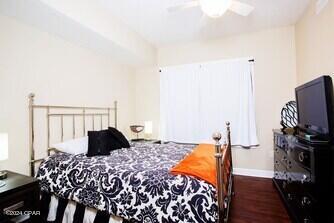 bedroom with ceiling fan and dark hardwood / wood-style flooring