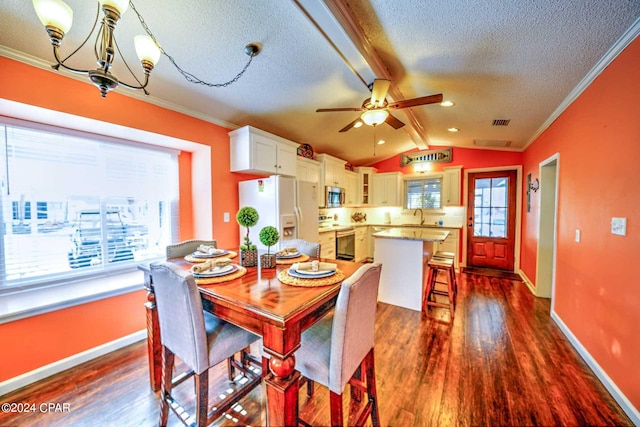 dining room with lofted ceiling, dark hardwood / wood-style floors, ceiling fan with notable chandelier, and sink