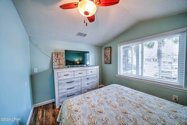 bedroom featuring lofted ceiling, ceiling fan, and dark hardwood / wood-style flooring