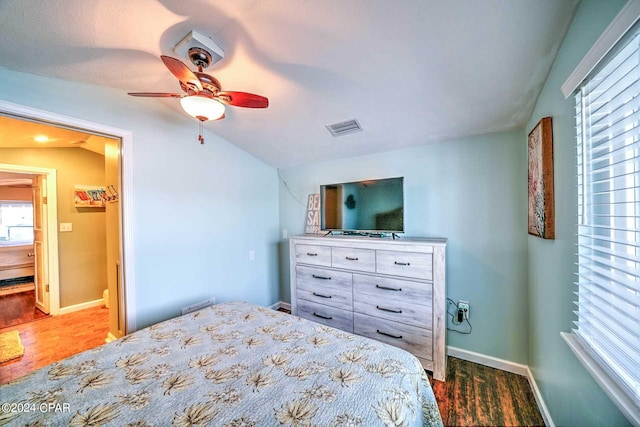 bedroom with dark hardwood / wood-style flooring and ceiling fan