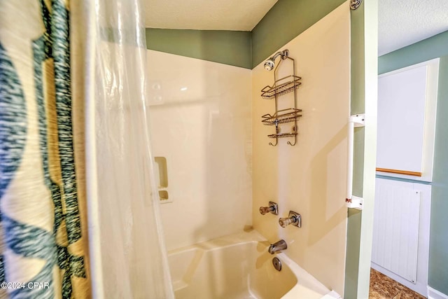 bathroom with shower / tub combo and a textured ceiling