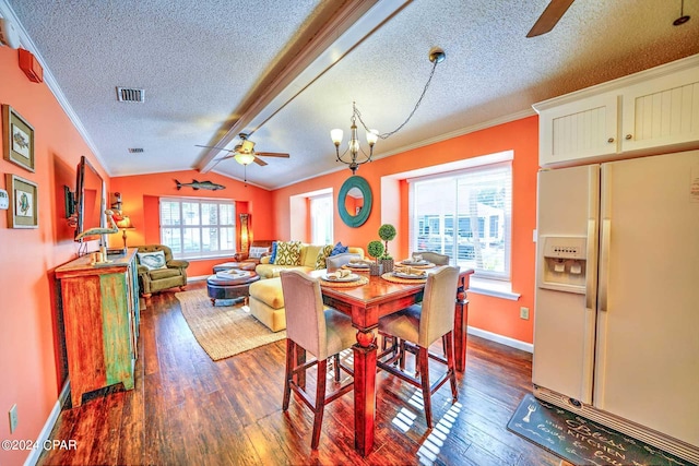 dining area featuring a healthy amount of sunlight, vaulted ceiling with beams, dark hardwood / wood-style floors, and ceiling fan with notable chandelier