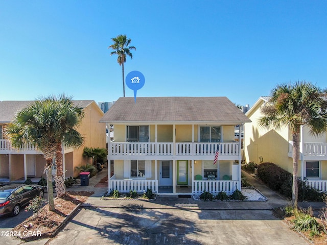 view of front of property featuring a balcony and covered porch