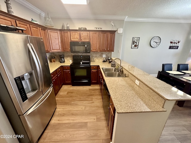 kitchen featuring backsplash, light hardwood / wood-style flooring, stove, stainless steel refrigerator with ice dispenser, and sink