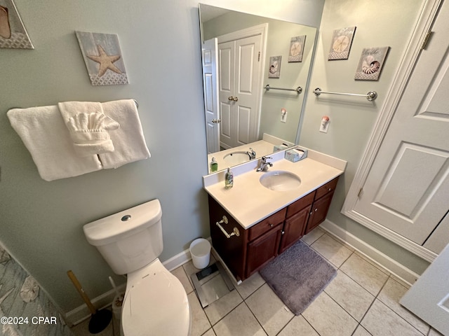 bathroom with toilet, tile flooring, and large vanity