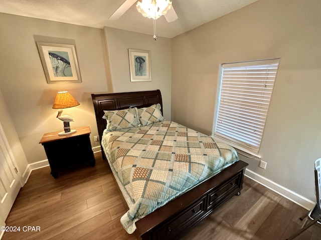 bedroom with dark wood-type flooring and ceiling fan