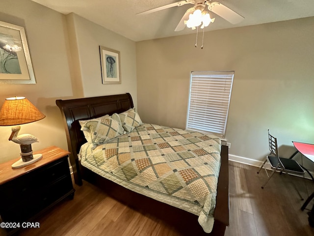 bedroom featuring dark hardwood / wood-style floors and ceiling fan