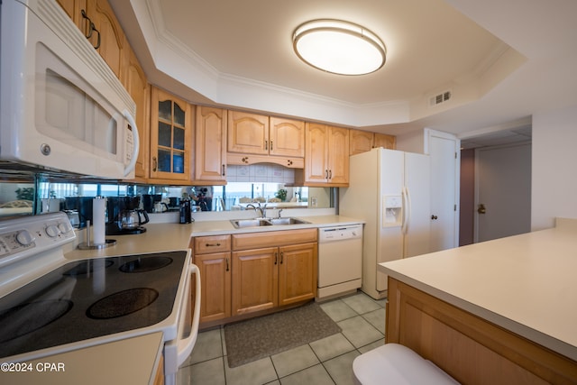 kitchen featuring a tray ceiling, white appliances, sink, light tile floors, and ornamental molding