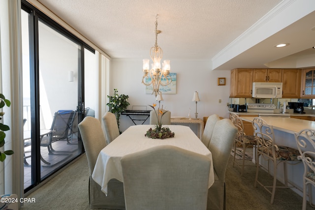 carpeted dining room featuring a chandelier, ornamental molding, and a textured ceiling