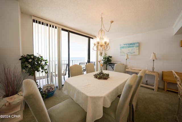 carpeted dining space with crown molding, a textured ceiling, expansive windows, and a chandelier