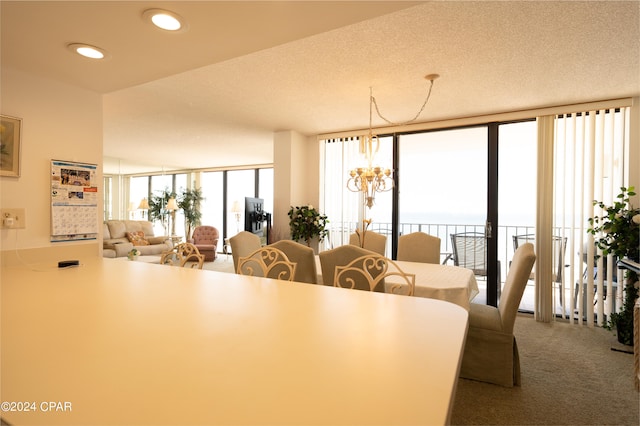 carpeted dining space featuring a wall of windows and a textured ceiling