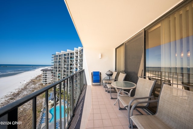 balcony with a beach view and a water view