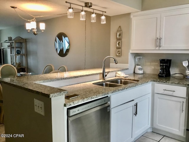 kitchen with tasteful backsplash, white cabinets, hanging light fixtures, dishwasher, and sink