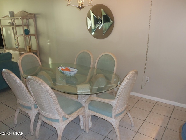 dining room featuring light tile floors and a chandelier