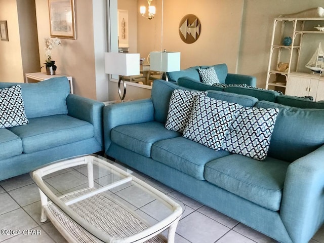 living room featuring a notable chandelier and light tile floors