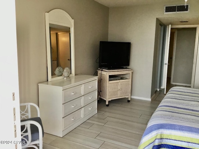 bedroom with light hardwood / wood-style floors