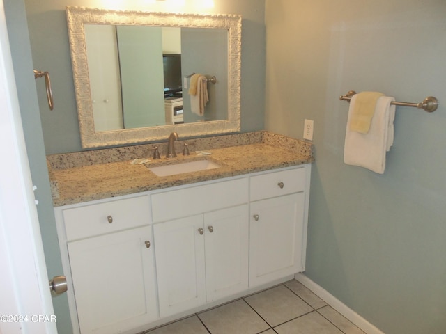 bathroom featuring vanity with extensive cabinet space and tile flooring