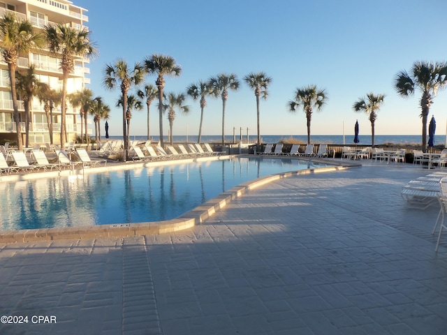 view of swimming pool with a water view