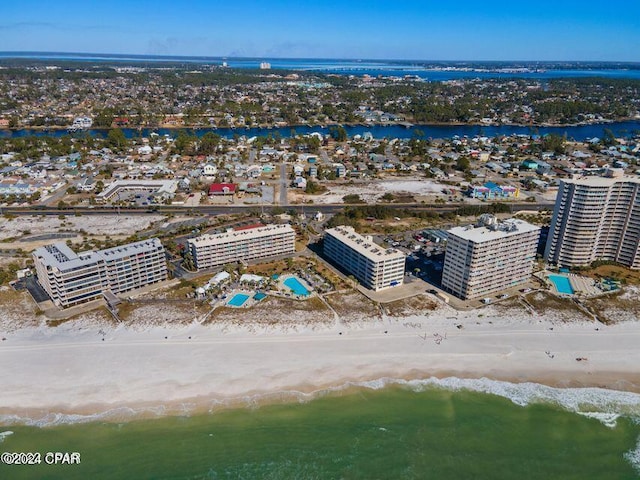 bird's eye view featuring a water view and a beach view