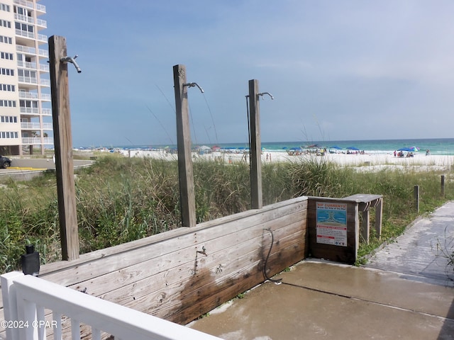 exterior space featuring a water view and a beach view