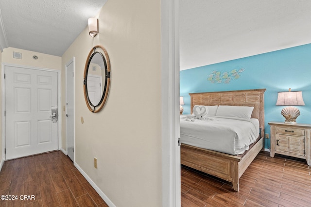 bedroom featuring a textured ceiling and wood-type flooring