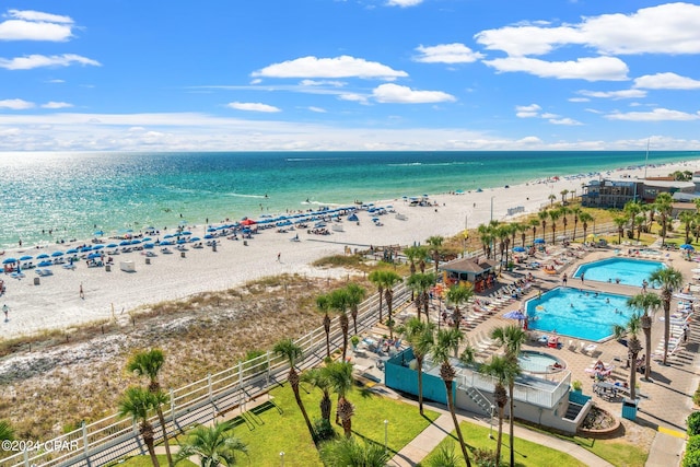 drone / aerial view with a beach view and a water view