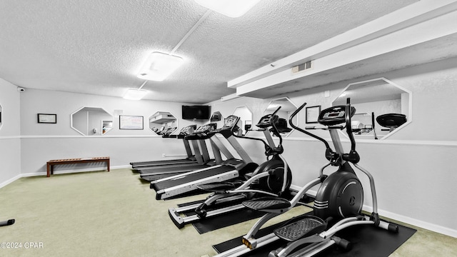 workout area with a textured ceiling and carpet