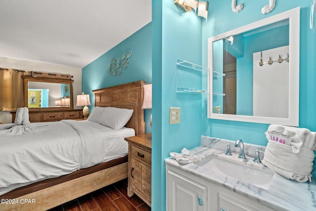 bedroom featuring sink and dark hardwood / wood-style flooring